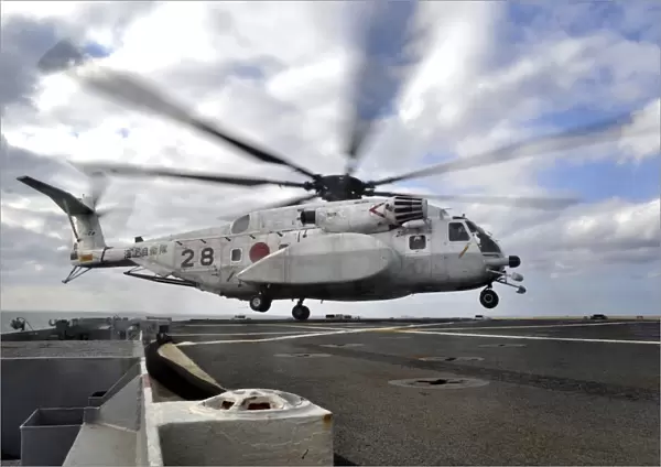 A Japanese Maritime Self-Defense Force MH-53 Sea Stallion lands on the flight deck