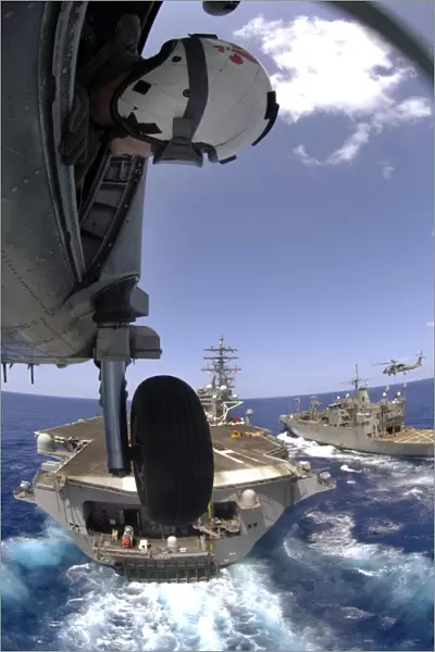 U. S. Navy Petty Officer leans out the door of an SH-60 Seahawk