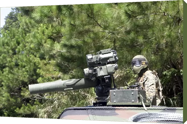 A tube-launched, optically-tracked, wire-guided missile gunner scans for threats