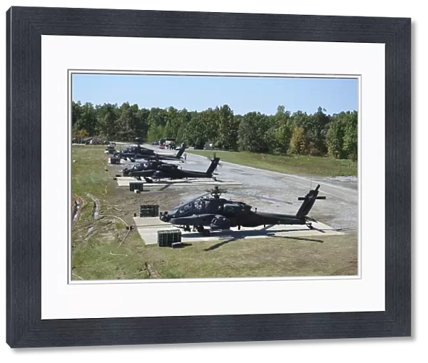 An air crew starts their AH-64D Apache helicopters at Fort Campbell