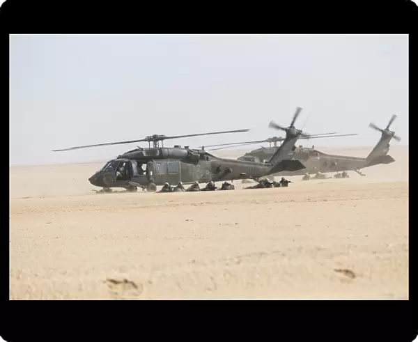 UH-60 Blackhawk helicopters air drop soldiers in Kuwait