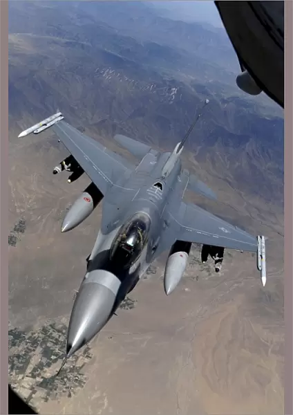 An F-16 Fighting Falcon returns to mission after refueling from a KC-135 Stratotanker