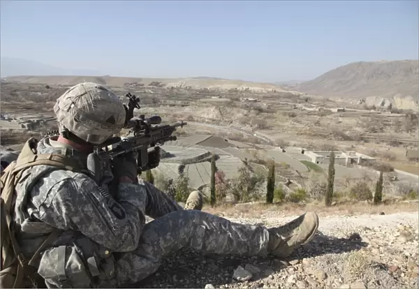 U.s Army soldier scans his sector of fire with his M14 rifle in Afghanistan