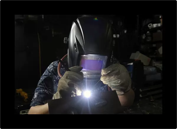 Maintenance Technician uses a tig welder to join two pieces of steel