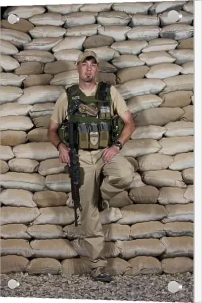 A U. S. police officer contractor leans against his bunker in Afghanistan