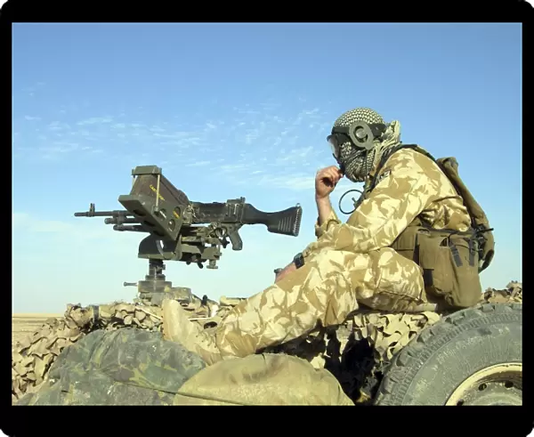 A gunner sits atop a British Army WMIK Land Rover