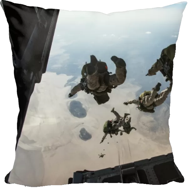 U. S. Pararescuemen and U. S. Marines jump from a HC-130 over Djibouti