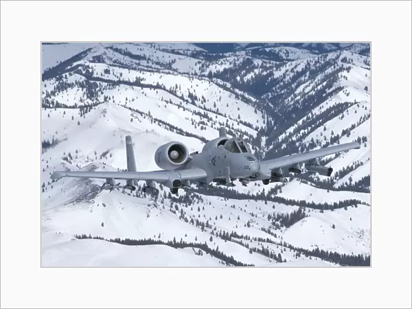 An A-10C Thunderbolt flies over the snowy Idaho countryside