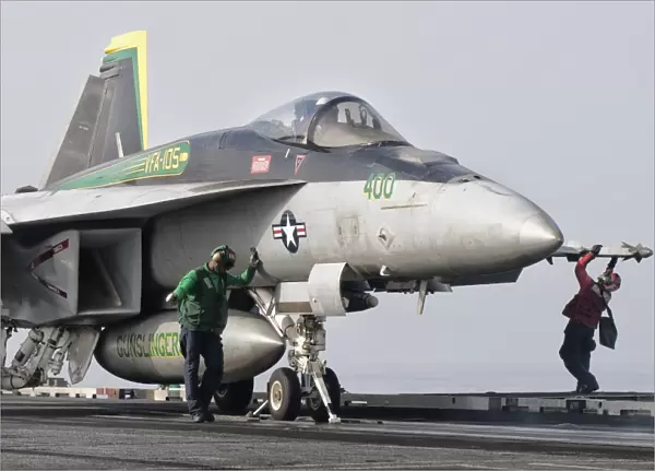 An F  /  A-18 Super Hornet is ready to launch from a catapult aboard USS Harry S. Truman