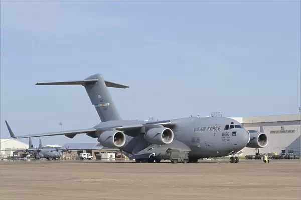 A C-17 Globemaster III parked on the ramp at an Air Force base