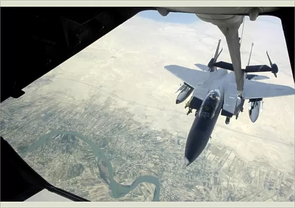 n F-15E Strike Eagle receives fuel from a KC-10 Extender