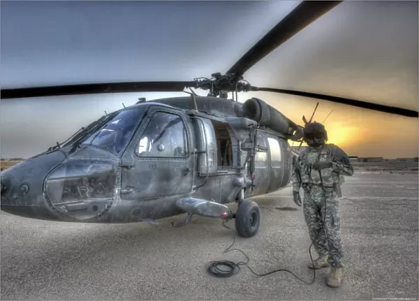 High dynamic range image of a door gunner beside a UH-60 Black Hawk