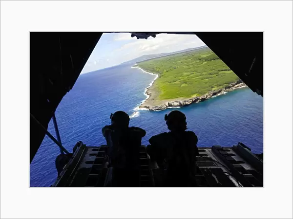 Loadmasters look out over Tumon Bay from a C-130 Hercules