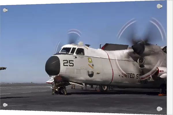 Aviation Boatswain Mate directs a C-2A Greyhound on the flight deck aboard USS Ronald