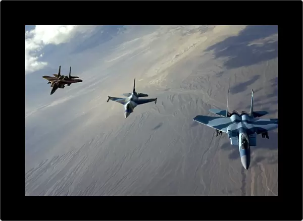 F-15 Eagles and a F-16 Fighting Falcon fly in formation
