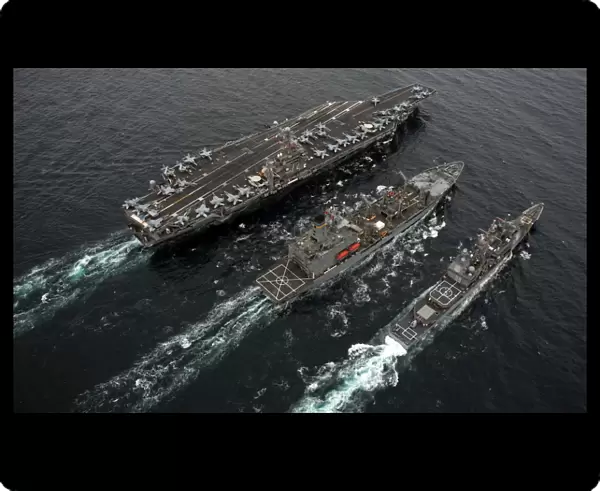 A replenishment at sea between USS Abraham Lincoln, USNS Guadalupe and USS Cape St