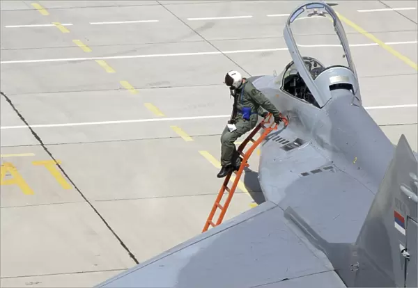 Serbian Air Force pilot climbs down from the cockpit of a MiG-29