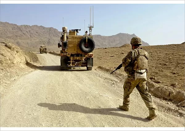 U. S. Army soldier moves to his MRAP vehicle in Afghanistan