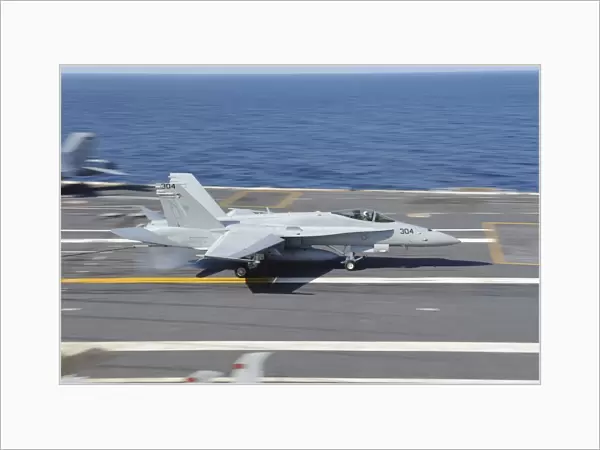 An F  /  A-18C Hornet lands aboard USS George H. W. Bush