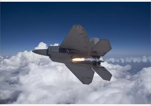 An F-22 Raptor releases a flare during a training mission