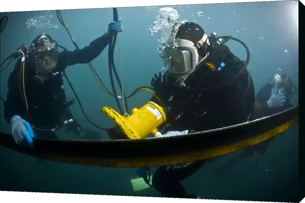 U. S. Navy Diver instructs a Barbados coast guard diver on using a hydraulic grinder