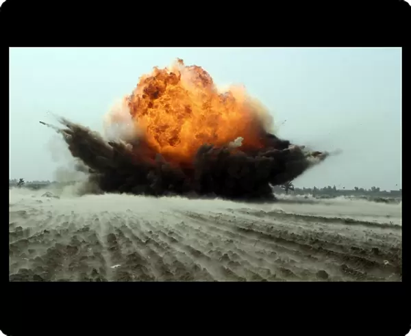 An explosion erupts from the detonation of a weapons cache