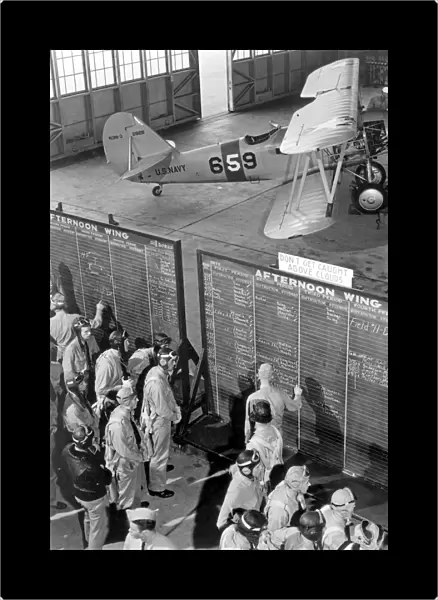 Aviation cadets check flight boards for last minute instructions