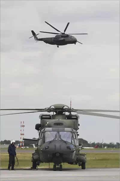 A German Army NH90 and its predecessor, the CH-53 Sea Stallion