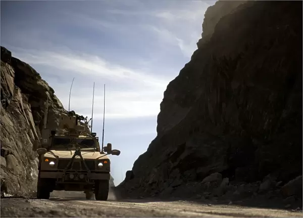 A MRAP vehicle drives through the mountains of Afghanistan