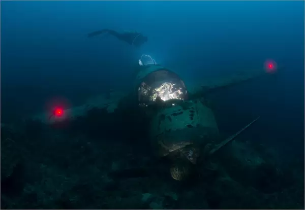 Diver exploring the wreck of a Japanese Navy Seaplane in Palau, Micronesia