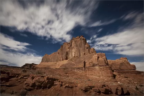 Red rock formation illuminatd by moonlight in Arches National Park, Utah