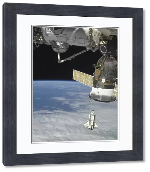 Space shuttle Endeavour, a Soyuz spacecraft, and the International Space Station