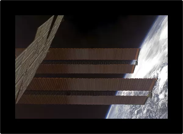 International Space Stations solar array panels and Earths horizon
