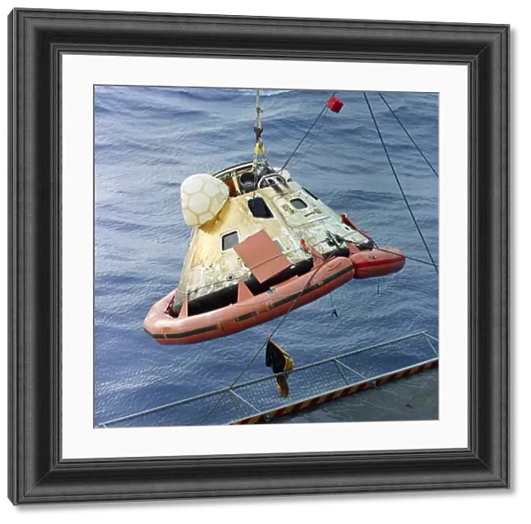 The Apollo 8 capsule being hoisted aboard the recovery carrier