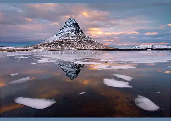 Kirkjufell mountain at dawn with ice in foreground, Snaefellsnes peninsula, Iceland, January 2014