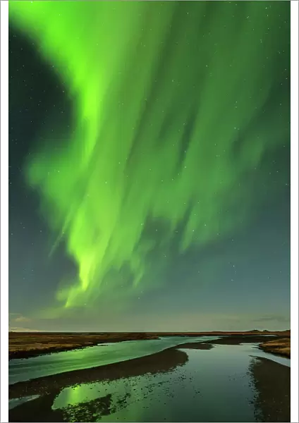 The Northern Lights  /  Aurora Borealis over a river, Vik, Iceland. February 2014