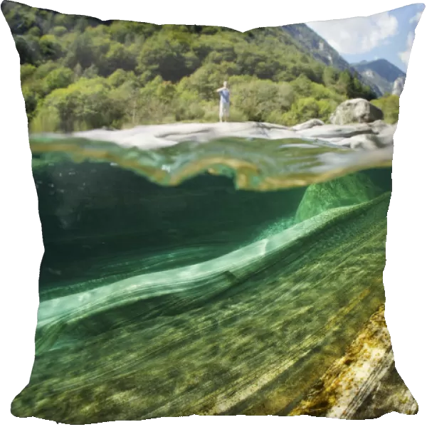Split level view of blue green waters of Verzasca River flowing over granite rocks at Lavertezzo
