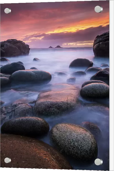 Sea and stones at Porth Nanven beach, with rising tide at sunset, The Cot Valley