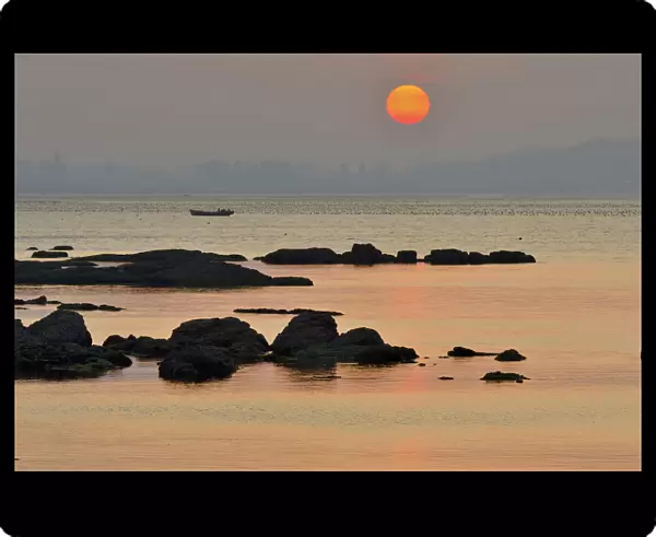 Rocks along Yellow Sea coast at sunset. Yangma Island, Yantai, Shandong Province, China