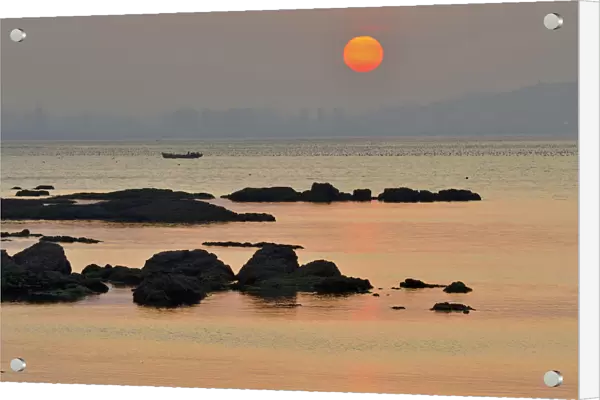 Rocks along Yellow Sea coast at sunset. Yangma Island, Yantai, Shandong Province, China