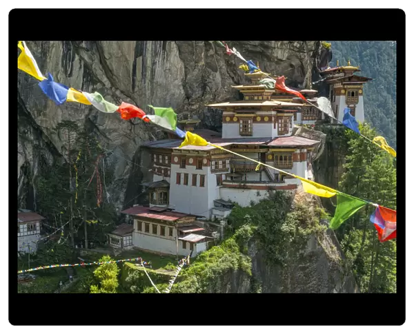 Paro Taktsang  /  Tigers Nest Buddhist monastery perched on cliffs with prayer flags