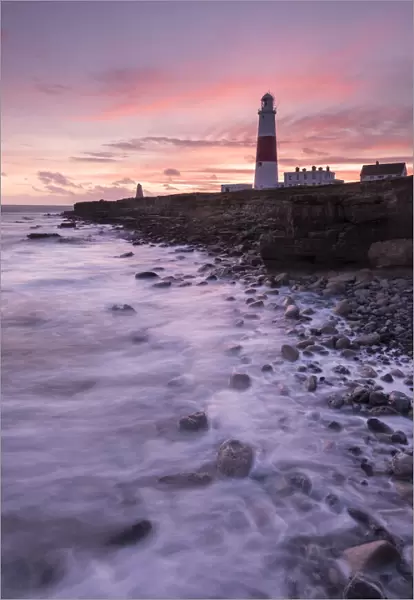 Coastline and Portland Bill Lighthouse at sunset. Isle of Portland, Dorset, England, UK. January 2016