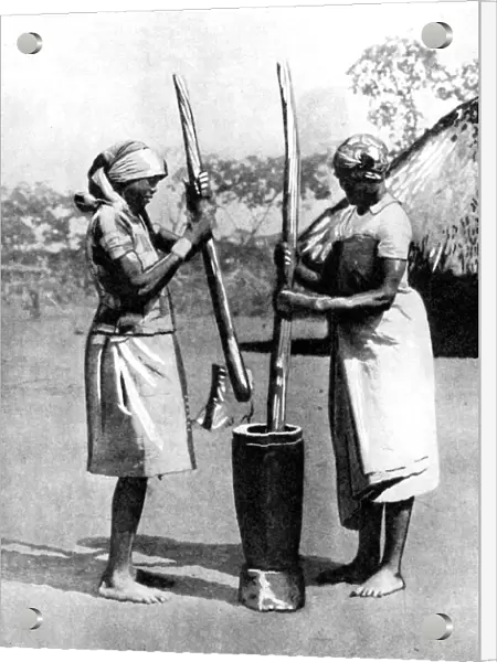 Two Mashona tribeswomen pounding maize and millet, Zimbabwe, Africa, 1936. Artist: Wide World Photos