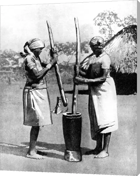 Two Mashona tribeswomen pounding maize and millet, Zimbabwe, Africa, 1936. Artist: Wide World Photos