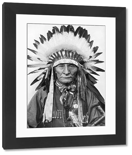 A Native American chief wearing his headdress