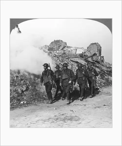 Troops passing the ruins of Monchy on the way up the line, France, World War I, c1914-c1918. Artist: Realistic Travels Publishers