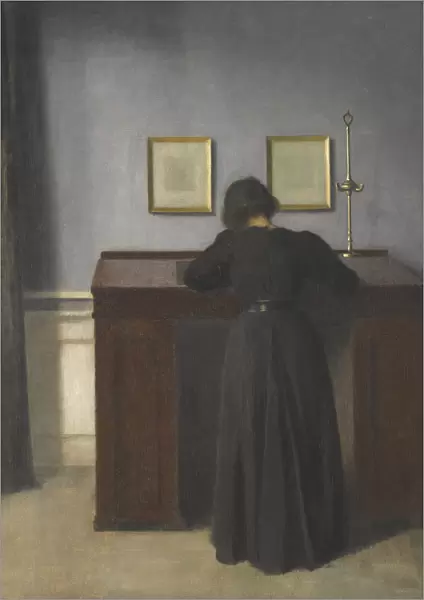 Ida Standing at a Desk. Artist: Hammershoi, Vilhelm (1864-1916)