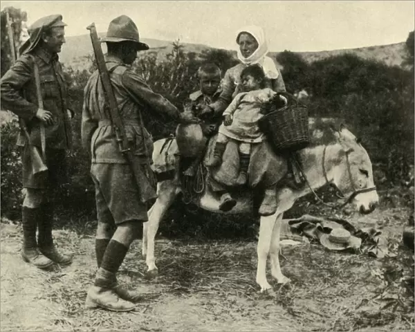 Australian soldier giving water to a Turkish family, First World War, 1915-1916, (c1920)
