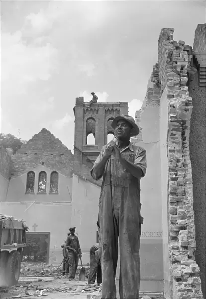 Construction workman wrecking a church on Independence Avenue, Washington, D. C, 1942. Creator: Gordon Parks