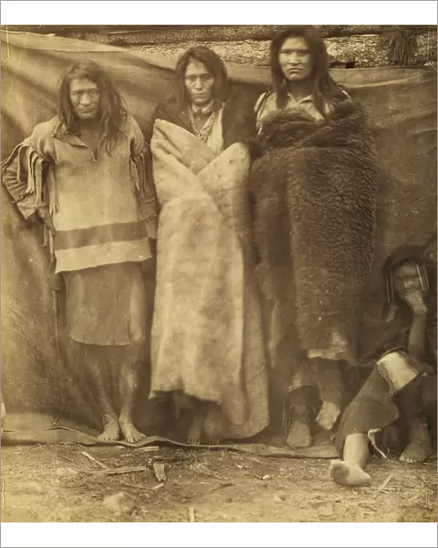 Group of Native Americans, three standing, one seated on the ground, possibly... 1860 or 1861. Creator: Unknown